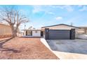 Modern single story home with a two car garage and gravel yard at 6005 W Washington Ave, Las Vegas, NV 89107