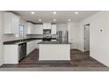 Modern kitchen featuring white cabinets, stainless steel appliances, and a kitchen island at 6240 Blood Lily Ave, Las Vegas, NV 89122