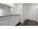 Clean bathroom with gray countertop, white cabinets, and a walk-in shower at 6270 Blood Lily Ave, Las Vegas, NV 89122