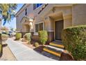 Front entrance of townhouse with walkway and landscaping at 6529 Za Zu Pitts Ave # 102, Las Vegas, NV 89122