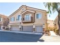 Townhouse exterior with two-car garage and balcony at 6529 Za Zu Pitts Ave # 102, Las Vegas, NV 89122