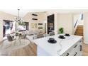 Modern kitchen with white cabinets and a large island at 6628 Silver Penny Ave, Las Vegas, NV 89108