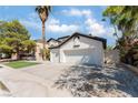 Two-story house with a three-car garage and desert landscaping at 6808 Rose Petal Ave, Las Vegas, NV 89130