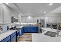 Modern kitchen featuring blue cabinets, quartz countertops, and stainless steel appliances at 7420 Bush Garden Ave, Las Vegas, NV 89129