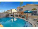 Inviting swimming pool with a large patio and covered seating area at 7420 Bush Garden Ave, Las Vegas, NV 89129