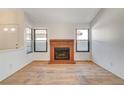 Living room with brick fireplace and wood flooring at 759 Whispering Palms Dr, Las Vegas, NV 89123