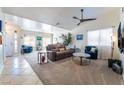 Spacious living room featuring a leather sectional sofa, large windows, and neutral carpeting at 848 Waterloo Dr, Henderson, NV 89002