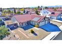 Single-story house with red tile roof, two-car garage, and spacious yard at 8517 Soneto Ln, Las Vegas, NV 89117