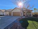 Two-story house with attached garage and landscaped yard at 865 Gleamstar Ave, Las Vegas, NV 89123