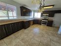 Spacious kitchen with dark wood cabinets and granite counters at 865 Gleamstar Ave, Las Vegas, NV 89123