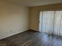 Spacious bedroom with wood-look floors and window coverings at 3051 Key Largo Dr # 104, Las Vegas, NV 89120