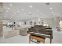 Bright open floor plan with piano, living, and dining areas, enhanced by abundant natural light and stylish decor at 3104 Conners Dr, Las Vegas, NV 89107