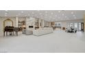 Expansive living room with fireplace and piano, seamlessly flowing into the dining and kitchen areas at 3104 Conners Dr, Las Vegas, NV 89107