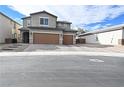 Two-story house with brown garage doors and a paved driveway at 3439 Midnight Shadows Way, North Las Vegas, NV 89032