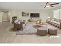 Virtually staged living room with comfortable seating and large TV at 347 S Milan St, Henderson, NV 89015