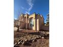 Charming two-story home featuring a stucco exterior, tiled roof, and desert landscaping at 4466 Palm Grove Dr, Las Vegas, NV 89120