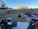 Large backyard with gravel, a fire pit, and basketball hoop at 6282 Dollar Bill Ct, Las Vegas, NV 89141