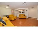 Open living room features hardwood floors and kitchen bar at 8600 W Charleston Blvd # 2101, Las Vegas, NV 89117