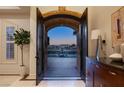 Elegant entryway with arched doorway revealing a courtyard and fountain at 9513 Verlaine Ct, Las Vegas, NV 89145