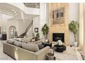 Living room with a stone fireplace, high ceilings and large windows at 9513 Verlaine Ct, Las Vegas, NV 89145