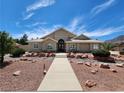Tan stucco home with tile roof and walkway at 121 E Cypress Dr, Henderson, NV 89015