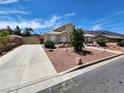 Landscaped front yard with driveway and gated entry at 121 E Cypress Dr, Henderson, NV 89015