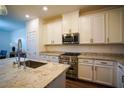 Bright kitchen featuring white cabinets and granite countertops at 161 Petaluma Valley Dr, Las Vegas, NV 89138