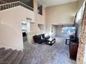 Spacious living room with high ceilings and neutral carpeting at 1808 Cedar Bluffs Way, Las Vegas, NV 89128