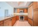 Modern kitchen with wood cabinets, granite counters, and stainless steel appliances at 222 Karen Ave # 2601, Las Vegas, NV 89109