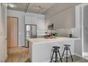 Modern kitchen with breakfast bar, two stools, and stainless steel appliances at 353 E Bonneville Ave # 457, Las Vegas, NV 89101