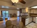 Open kitchen with living room view, granite countertops, and wood cabinets at 3761 Desert Marina Dr # 81, Laughlin, NV 89029