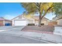 Charming single-story home with a well-maintained front yard and a two car garage at 4536 Rolls Royce Rd, North Las Vegas, NV 89031