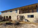 Two story home with covered patio and a large yard at 4980 W Weddle Way, Moapa, NV 89025