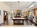 Spacious game room with pool table, fireplace, and ample seating at 7670 Frittata Ave, Las Vegas, NV 89113