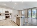 Open concept kitchen with island, stainless steel appliances, and granite countertops at 7745 Rosebark Cliffs St, North Las Vegas, NV 89084