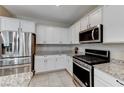 Modern kitchen with stainless steel appliances and granite countertops at 7745 Rosebark Cliffs St, North Las Vegas, NV 89084