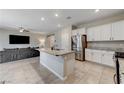 Open concept kitchen with island and stainless steel appliances at 7745 Rosebark Cliffs St, North Las Vegas, NV 89084