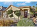 House exterior featuring a two-car garage and manicured landscaping at 8482 Lambert Dr, Las Vegas, NV 89147