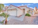 Spanish style home with a red tile roof, and a two-car garage at 9709 Peacock Hill Cir, Las Vegas, NV 89117