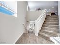 Modern staircase with carpet runner and wood flooring at 10581 Olinda St, Las Vegas, NV 89179