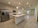 Modern kitchen with island, stainless steel appliances, and light gray cabinets at 11751 Emerald Lake Ave, Las Vegas, NV 89138