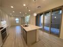 Modern kitchen with island, stainless steel appliances, and light gray cabinets at 11751 Emerald Lake Ave, Las Vegas, NV 89138