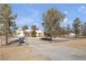 Gravel driveway leading to a house with chain link fence at 1230 Bruce St, Pahrump, NV 89048