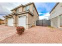 Side view of house showcasing garage and gated side yard at 1556 Bryce Canyon St, Boulder City, NV 89005