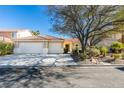 Single-story home with two-car garage and landscaped front yard at 160 Swale Ln, Las Vegas, NV 89144