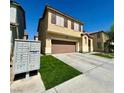 Two-story house with artificial turf and a community mailbox at 1908 W Hammer Ln, North Las Vegas, NV 89031