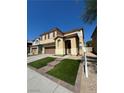 Two-story house with artificial turf and a landscaped front yard at 1908 W Hammer Ln, North Las Vegas, NV 89031