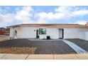 White single story home with a gravel front yard and walkway at 2781 Sandyfalls Way, Las Vegas, NV 89142