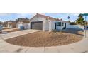 Charming curb appeal with a gray garage door and rock landscaping at 2781 Sandyfalls Way, Las Vegas, NV 89142