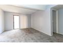 Spacious living room with neutral carpet, patio access, and sliding glass doors at 3790 Desert Marina Dr # 147, Laughlin, NV 89029